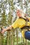 Young woman in climbing forest while rappelling