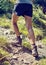 Young woman climbing a rocky mountain footpath