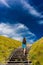 Young woman climbing stairs outdoors in an idyllic travel destin