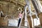 Young woman climbing up the ladder while looking at ceiling