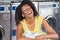 Young Woman With Clothes Basket At Laundromat