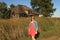 Young woman and collapsing building on a breezy country day