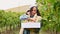 Young woman collects grapes in the vineyards. Hills of italy, harvesting in tuscany.
