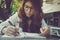 Young woman concentrate reading book. girl learning writing home