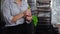 Young woman confectioner preparing pastry bag for work. Green pastry bag filled with white cream. Culinary, desserts