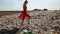 Young woman confidently walks over huge pile of trash