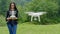 Young woman controlling drone with a transmitter remote control