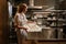 Young woman cook preparing meals for a restaurant in kitchen