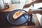 Young woman cooking bread breakfast on counter bar kitchen