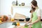 Young woman cooking in the kitchen. Housewife slicing fresh salad