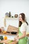 Young woman cooking in the kitchen. Housewife slicing fresh salad