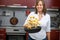 Young woman cooking potatoes in the kitchen