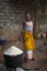 Young woman cooking rice in an old pan, at the Cupelon de Cima neighborhood in the city of Bissau