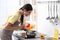 Young woman cooking tasty soup