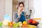 Young woman cooking veggie soup