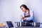 A young woman is cooks while watching a video on a tablet