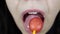 Young woman coquette girl with lollipop. Sexy woman with lips holding lollipop, beauty closeup