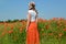 The young woman costs in a poppy field