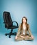 Young woman in costume sitting in lotus pose