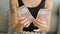 Young woman counting india rupiah banknotes at home