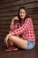 Young woman in cowboy clothes over wood