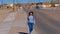Young woman with a cowboy hat walking through a lonesome street in Dolan Springs Arizona