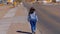 Young woman with a cowboy hat walking through a lonesome street in Dolan Springs Arizona