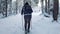 Young woman cross-country skiing on beautiful snowing day in forest