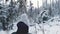 Young woman cross-country skiing on beautiful snowing day in forest