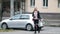 Young woman crosses road. Blonde in black jeans walks along pedestrian crossing.