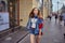 Young woman on a crowded street in the center of the russian city of St. Petersburg on a summer day