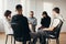 Young woman crying during widowers support group meeting