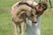 Young woman cuddling with her best friend, falcon color stallion foal, share a loving moment