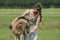 Young woman cuddling with her best friend, falcon color stallion foal, sharing love and mutual affection