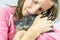 Young woman cuddling with her dog