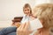 Young woman is curious and anticipating good news from her mother who is talking on the phone