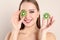 Young woman with cut kiwi on background. Vitamin rich food