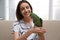 Young woman with cute Alexandrine parakeet