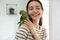 Young woman with cute Alexandrine parakeet