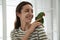 Young woman with cute Alexandrine parakeet