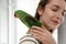 Young woman with cute Alexandrine parakeet