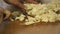 Young Woman Cuts Boiled Chicken On A Wooden Board.