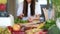 Young woman cutting spinach on wooden board