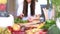 Young woman cutting spinach on wooden board