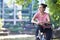 Young Woman Cycling Next To River In Urban Setting