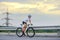 Young Woman Cyclist Riding Road Bike at Sunset. Adventure, Healthy Lifestyle, Sport