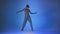 Young woman dancing house, energy jumps on blue background, studio shot