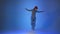 Young woman dancing house, energy jumps on blue background, studio shot