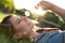 Young woman with dandelion in park. Allergy free concept