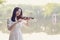 Young woman Dedicated playing violin ,Silhouette of teenage violin player over sunset on river,lake